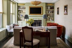 a living room filled with furniture and a fire place in the middle of a room