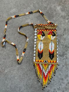 This beautiful handcrafted glass seed bead bag is approximately 10" x 4" and was handcrafted by an Indigenous craftsperson in the highlands of Guatemala. Handmade Shoulder Phone Bag For Gift, Handmade Phone Shoulder Bag For Gift, Beaded Rectangular Shoulder Bag For Festivals, Beaded Bags For Everyday Use And Festivals, Artisan Brown Beaded Bag, Beaded Shoulder Bag For Festivals Gift, Traditional Beaded Shoulder Bag As Gift, Everyday Beaded Bags For Festivals, Artisan Beaded Rectangular Bag