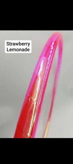 a close up of a pink and yellow object with the words strawberry lemonade on it