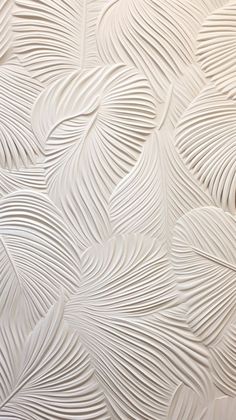 an abstract white wallpaper pattern with wavy lines and leaves on it's surface