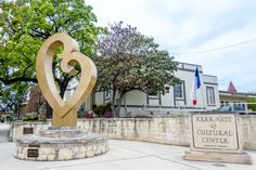 a large heart statue sitting in front of a building