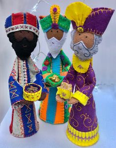 three colorful dolls are standing next to each other