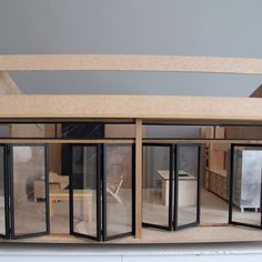 the inside of a model house with glass doors