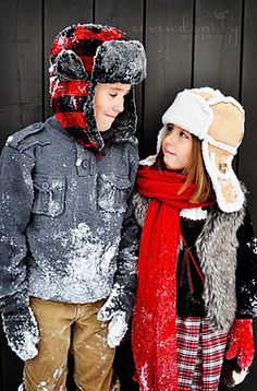 two people standing next to each other in the snow