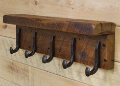 a wooden coat rack with four hooks on it