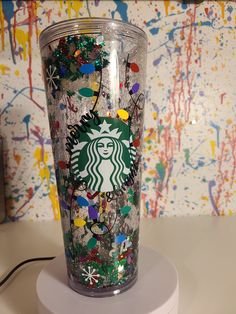 the starbucks cup is decorated with colorful confetti and sprinkles on it