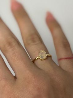 Beautiful blue needle double point ring set in gold-plated adjustable S925 ring.  A type of clear quartz with blue needle-like inclusions caused by trapped gasses during the formation of the stone. There are different reasons why the lines within the quartz give off a "blue hue" but the Tyndall Effect is known for scattering light particles in a colloid or in a very fine suspension. The color is blue light wavelength that is scattered much more strongly than red.  A calming stone which protects from negativity.  Also known as angel feathers.  Set in S925 adjustable ring band. All items in my shop are 100% from nature. They have not been heat-treated or aura colored. They have been mined, polished and set in to minimalistic jewelry settings. Gold Minimalist Crystal Ring With Moonstone, Minimalist Gold Moonstone Crystal Ring, Adjustable Oval Gold Moonstone Ring, Adjustable Gold Oval Moonstone Ring, Adjustable Gold Crystal Ring With Moonstone, Adjustable Yellow Gold Moonstone Open Ring, Minimalist Open Moonstone Ring In Gold, Gold Minimalist Crystal Ring With Prong Setting, Minimalist Gold Open Moonstone Ring