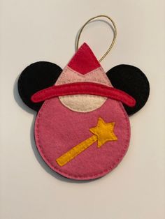 a mickey mouse ornament with a hat on it's head and a star