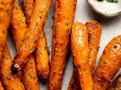 baked sweet potato fries with parsley on the side and dipping sauce in a small bowl