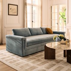 a living room with a blue couch and coffee table