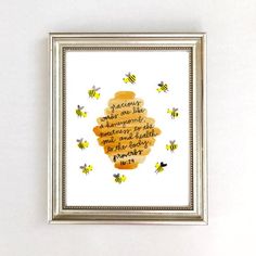 a frame with some writing on it and bees around the frame, all in different colors