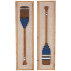 two wooden paddles with blue and white stripes are in a display case on the wall