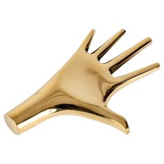 a gold colored metal object that looks like a hand