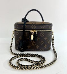 MODEL TITLE - Louis Vuitton Reverse Monogram Canvas Vanity PM Crossbody Shoulder Handbag CONDITION - Exceptional! Notable condition details: Like new! SKU - 6310 MODEL # - M45165 STYLE TYPE - Shoulder or Satchel or Crossbody DATE/SERIAL CODE - PL2260 ORIGIN - Italy PRODUCTION - 2020 DIMENSIONS - L7.3 x H5.1 x D4.2 STRAP/HANDLE DROP - 2 and 18 STRAP/HANDLE STYLE - Single Top Handle and a leather and chain entwined Strap INTERIOR LINING - Black Alcantara INTERIOR POCKETS - 1 Slip EXTERIOR POCKETS Louis Vuitton Vanity, Vuitton Outfit, Luxury Bags Collection, Louis Vuitton Shoulder Bag, Brown Canvas, Shoulder Handbag, Monogram Canvas, Authentic Louis Vuitton, Shoulder Handbags