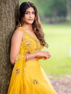 This yellow mirror lehenga is covered with embroidered butis.  It is paired with an intricately hand embellished blouse.  The outfit is completed with a tulle dupatta with butis and cutwork border.
*Sale on our Ready-To-Ship sizes S/M Mirror Lehenga, Yellow Mirror, Mirror Work Lehenga, Yellow Mirrors, Work Lehenga, Embellished Blouse, 12 Weeks, The Outfit, Mirror Work