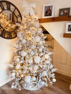 a white christmas tree decorated with ornaments and lights