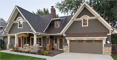 a gray house with white trim and two car garages