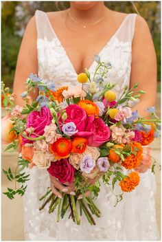 a woman holding a bouquet of flowers in her hands