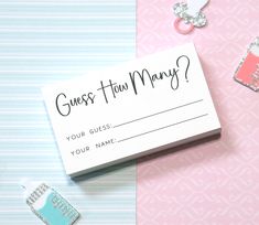 a business card sitting on top of a table next to some charms and magnets