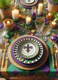 a table set with plates, silverware and candles for a mardi gras party