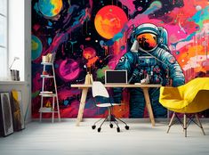 an astronaut themed wallpaper mural in a home office with colorful paint splattered walls