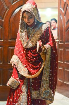 a woman in a red and gold wedding dress