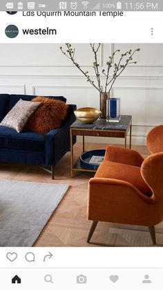 a living room with two chairs and a table in the middle, one has a vase on it