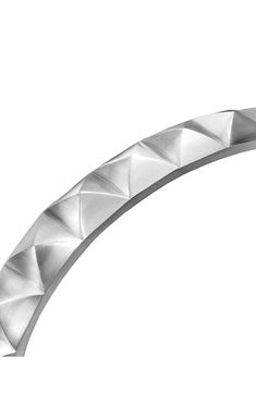 a curved metal object on a white background