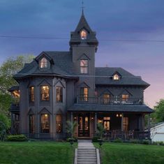 a large house sitting on top of a lush green field