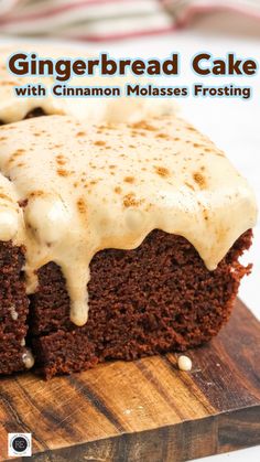 a close up of a piece of cake on a wooden cutting board with frosting