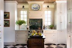 a kitchen with black and white checkered flooring, an island in the middle