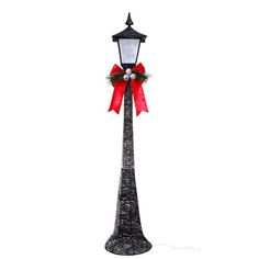 a street light with a red bow on it