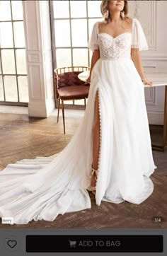 a woman in a white wedding dress posing for the camera