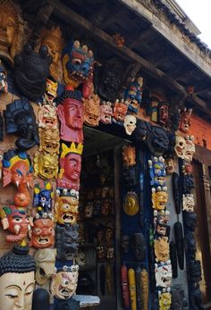 many colorful masks are hanging on the wall