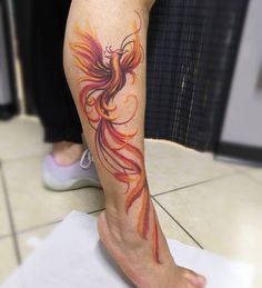 a woman's leg with a tattoo on it and a bird in the middle