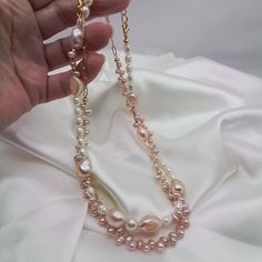 Two Pretty baby pink pearl necklaces. Both are sold together for the price of $50.00  one necklace has large pink baroque pearls and white rice pearls mixed Intermittently.  The other has small dainty pink baroque baby pearls .A lovely mix of quality natural freshwater pearls. A beautiful gift for your wife girlfriend sweetheart or just a new addition to your jewelry box.   These necklaces will be a staple for your feminine outfits.  Ready to dispatch to you in one business day..my handmade items are one of a kind....special and distinctive.   Thanks for visiting my shop GemsbyZoey... Pink Pearl Jewelry With Pearl Chain, Elegant Pink Pearl Drop Necklace, Pink Pearl Charm Necklace For Wedding, Wedding Pink Pearl Charm Necklace, Handmade Pink Pearl Beaded Necklaces, Handmade Long Pearl Necklace, Pink Pearl Chain Necklace For Wedding, Handmade Pearl White Baroque Pearl Necklace, Pink Pearl Drop Beaded Necklaces With Round Beads