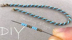 a beading needle being used to make a necklace