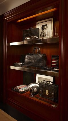 the shelves are filled with purses, hats and other personal items on display in this room