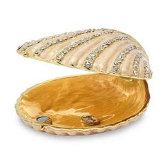 an open shell shaped dish with diamonds on it