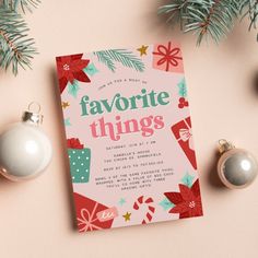 a pink christmas card with the words favorite things on it next to ornaments and decorations