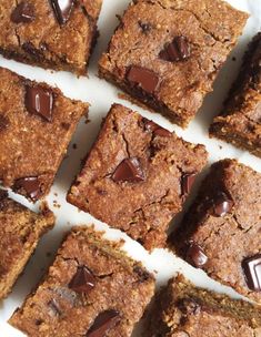 chocolate chip cookie bars cut into squares on a white plate