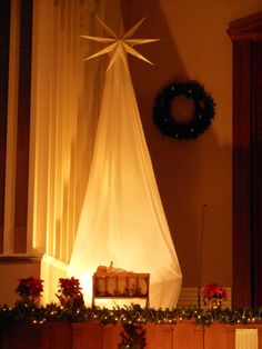 a christmas scene with a star on the top of a bed and decorations around it