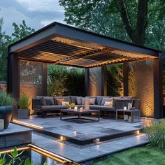 an outdoor living area is lit up at night