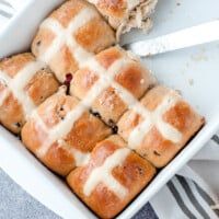 hot cross buns with icing in a white casserole dish