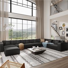 a modern living room with large windows and black couches