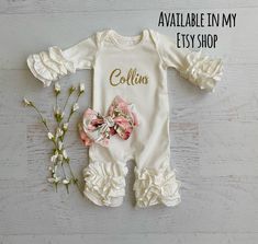 "Listing is for a cute cream colored romper with a dusty pink floral bunny on it. *You can choose to have a name at check out. *You can choose to have the matching headband at check out. This romper has a cute floral dusty pink vinyl bunny and your child's name going across the bunny in gold glitter or gold matte There are 2 bunnies to choose from. Please lmk which one you would like If you do not want the name on the romper just mark no personalization Please don't hesitate to ask if you have q Cute White Onesie With Ruffles, Cute White Ruffled Onesie, Spring White Ruffled Onesie, White Onesie For Baptism In Spring, Cute Cream Onesie For Spring, What Your Name, Navy Blue Girls Dress, 2 Bunnies, Shark Dress