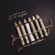 four candles are tied to a card that says, i hope that all your days be happy