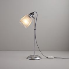 a desk lamp with a white light on it and a cord attached to the base