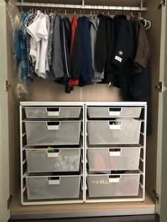 an organized closet with drawers and hanging clothes