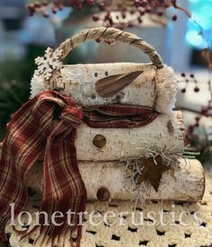 a close up of a bag made out of birch logs with a bird on top